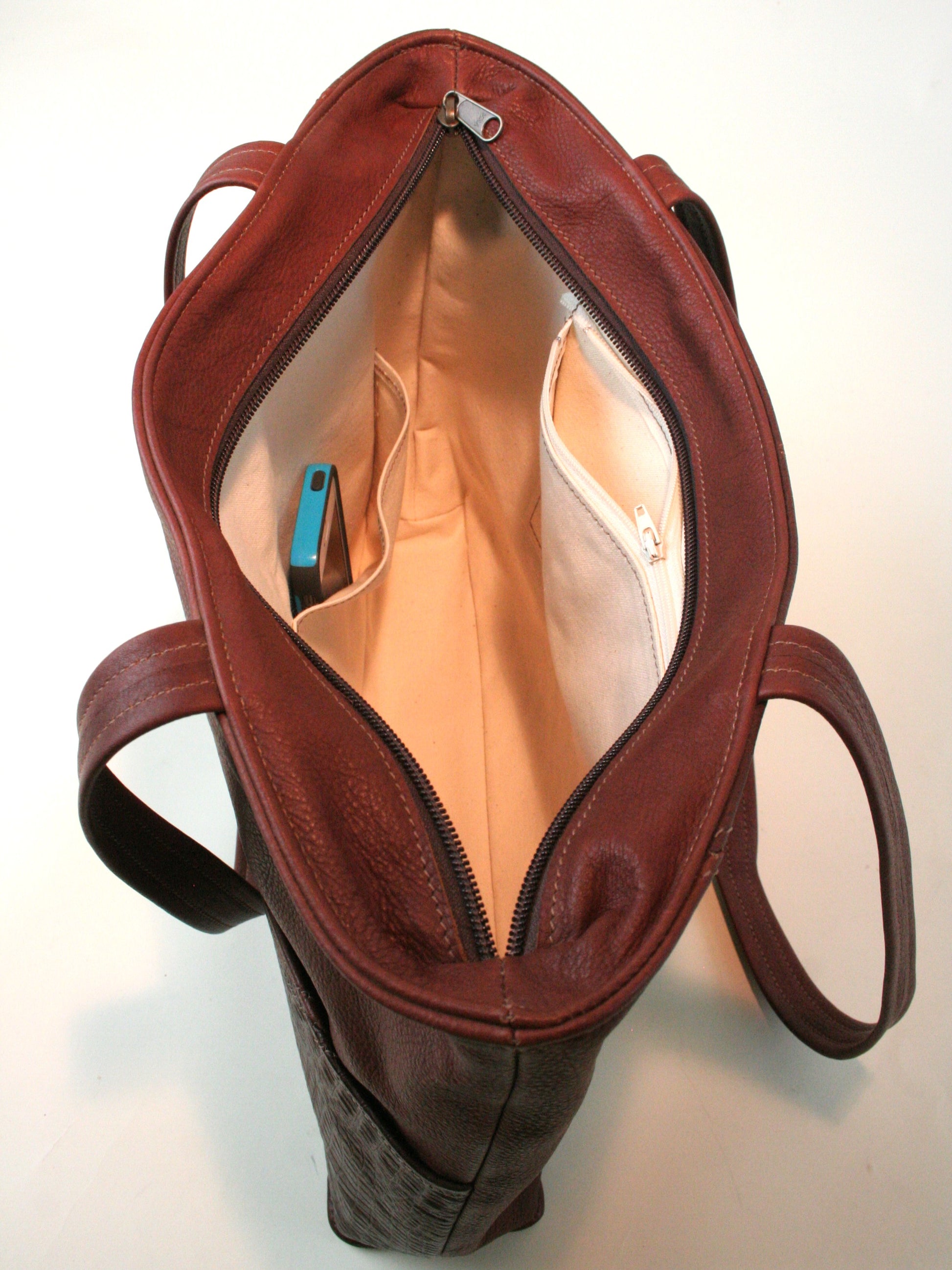 Canvas lined interior of leather tote bag.